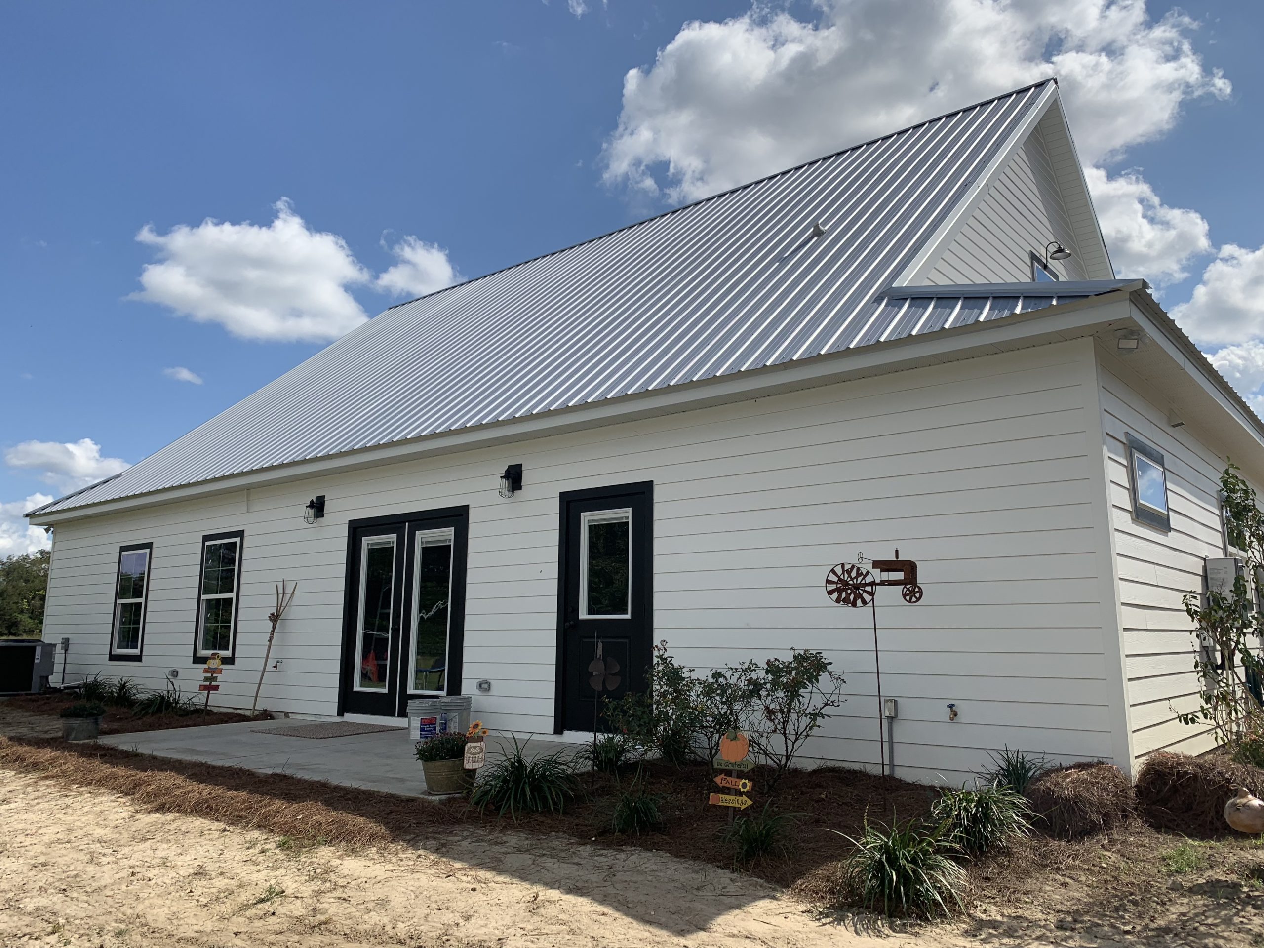 side view of a house with a steel roof and modern windows