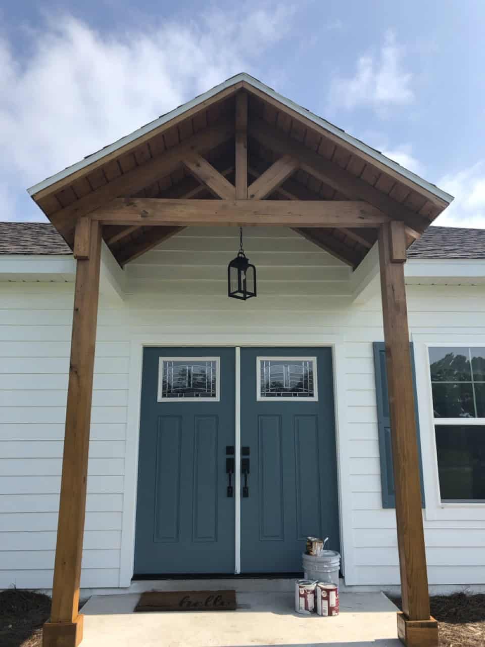 Front porch with double blue doors painted by Carter's