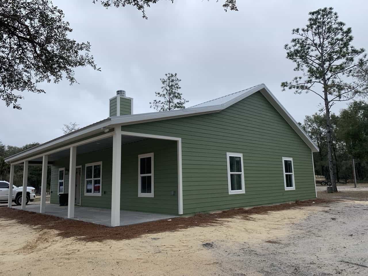 Green house with white trim
