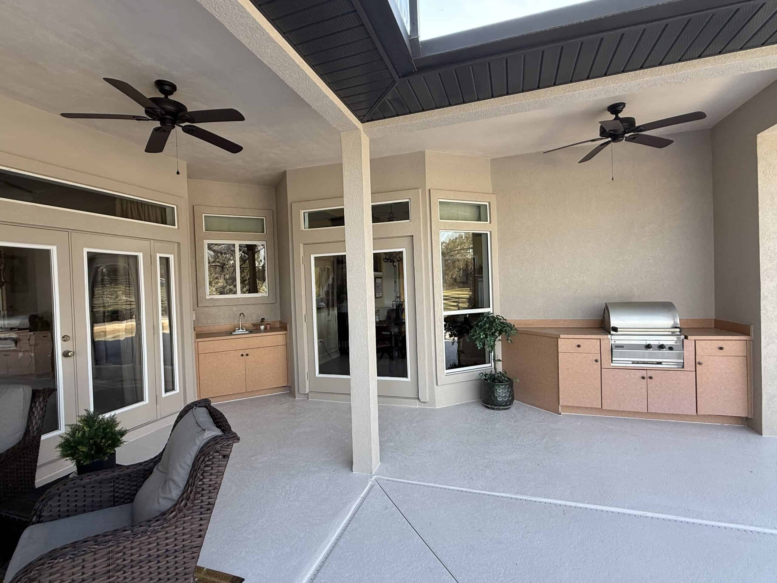 Covered porch with ceiling fans and outdoor kitchen